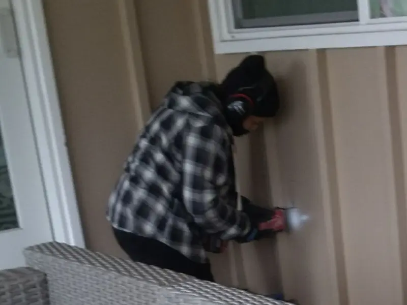 Professional electrician installing an exterior outlet in Huguley