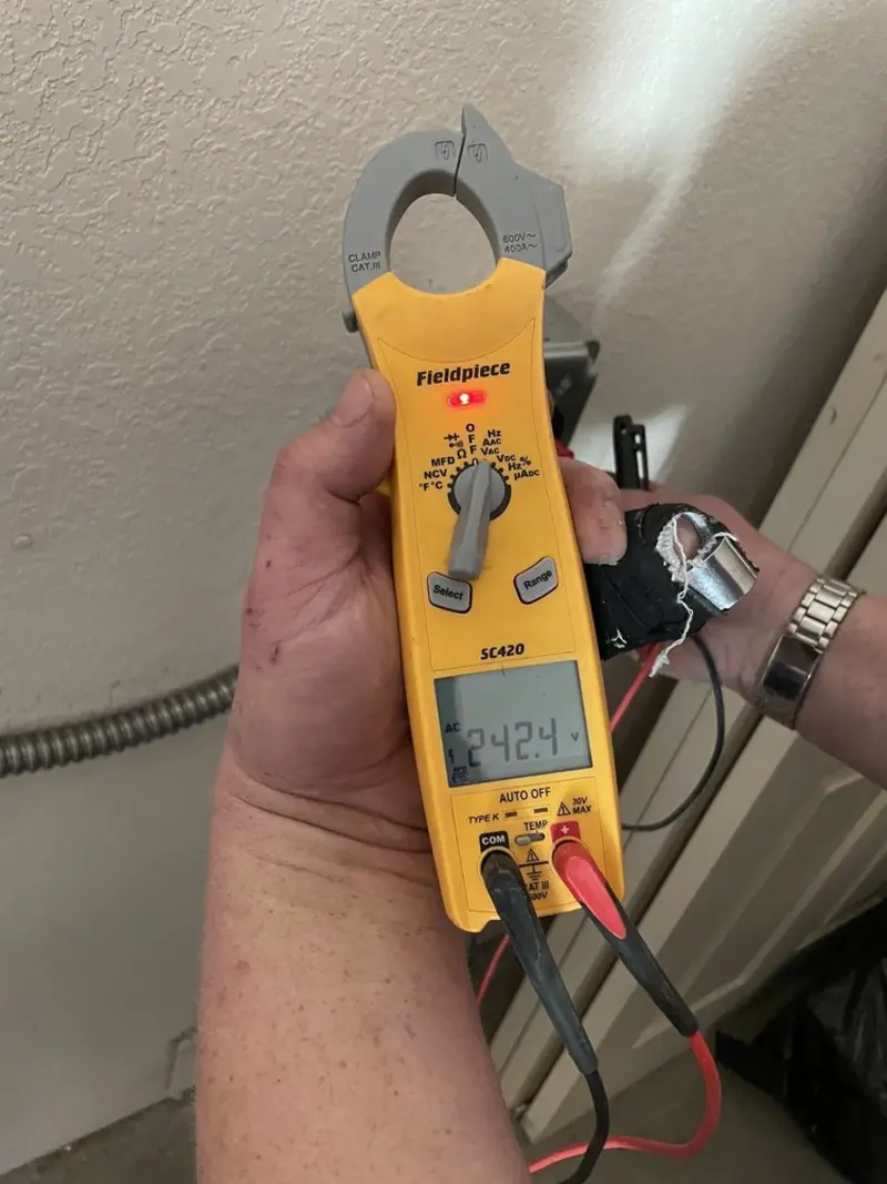 Voltage testing with clamp meter during Ceiling Fan Installation in Huguley
